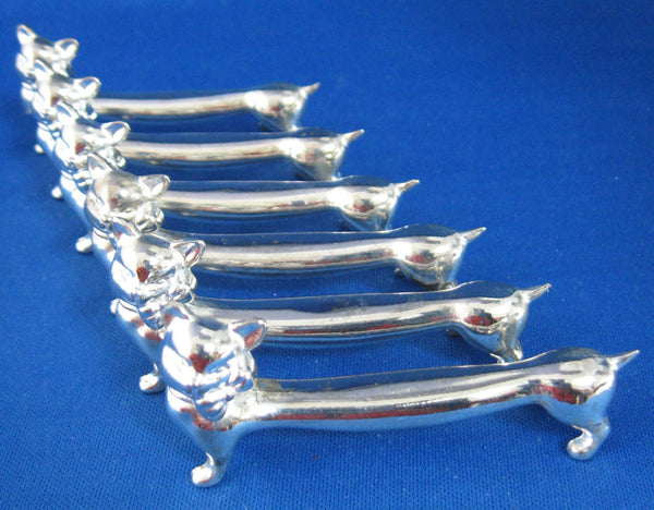 http://www.antiquesandteacups.com/cdn/shop/products/1940s-silverplate-cat-dog-kniferests-setof6-a_grande.jpg?v=1490486415